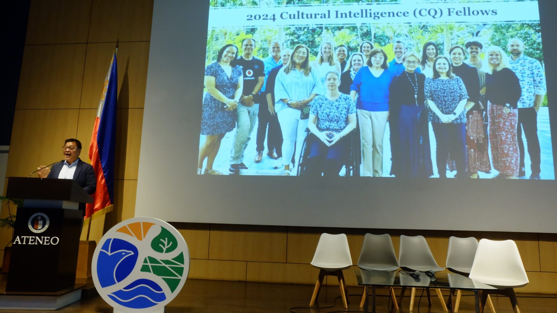 Ned Legaspi speaks at the AUN-EEC Conference while showing a presentation slide about the 2024 Cultural Intelligence Fellows.