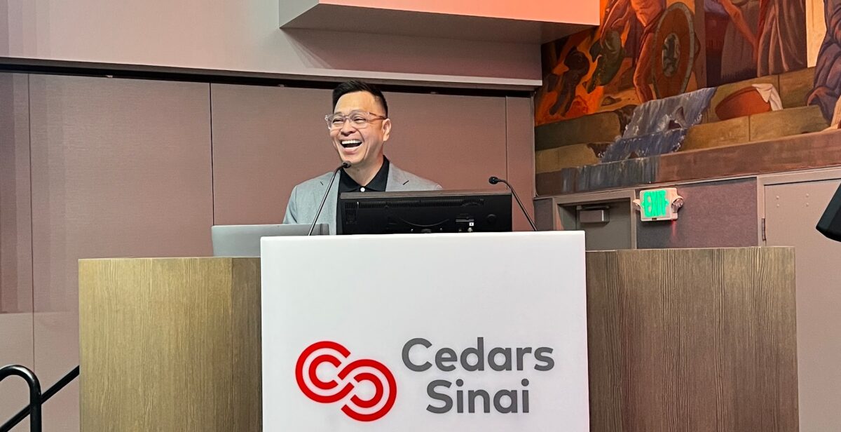 Ned Legaspi speaking at the podium during a Cultural Intelligence session at Cedars-Sinai Medical Center in Los Angeles.