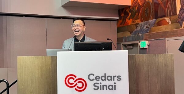 Ned Legaspi speaking at the podium during a Cultural Intelligence session at Cedars-Sinai Medical Center in Los Angeles.