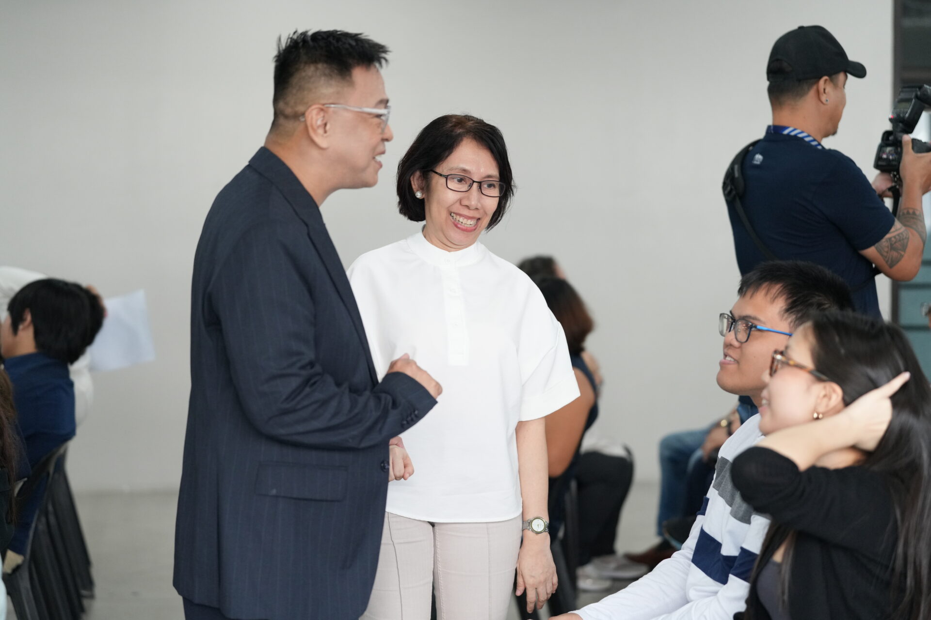 Ned Legaspi and PR professional Aileen Carreon speaking with media guests