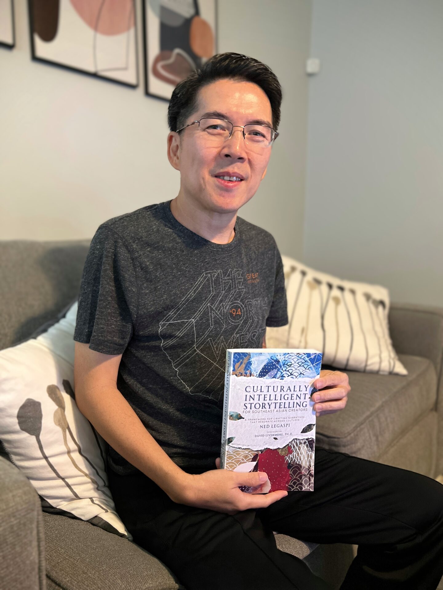 Alan Bautista with a copy of Culturally Intelligent Storytelling for Southeast Asian Creators