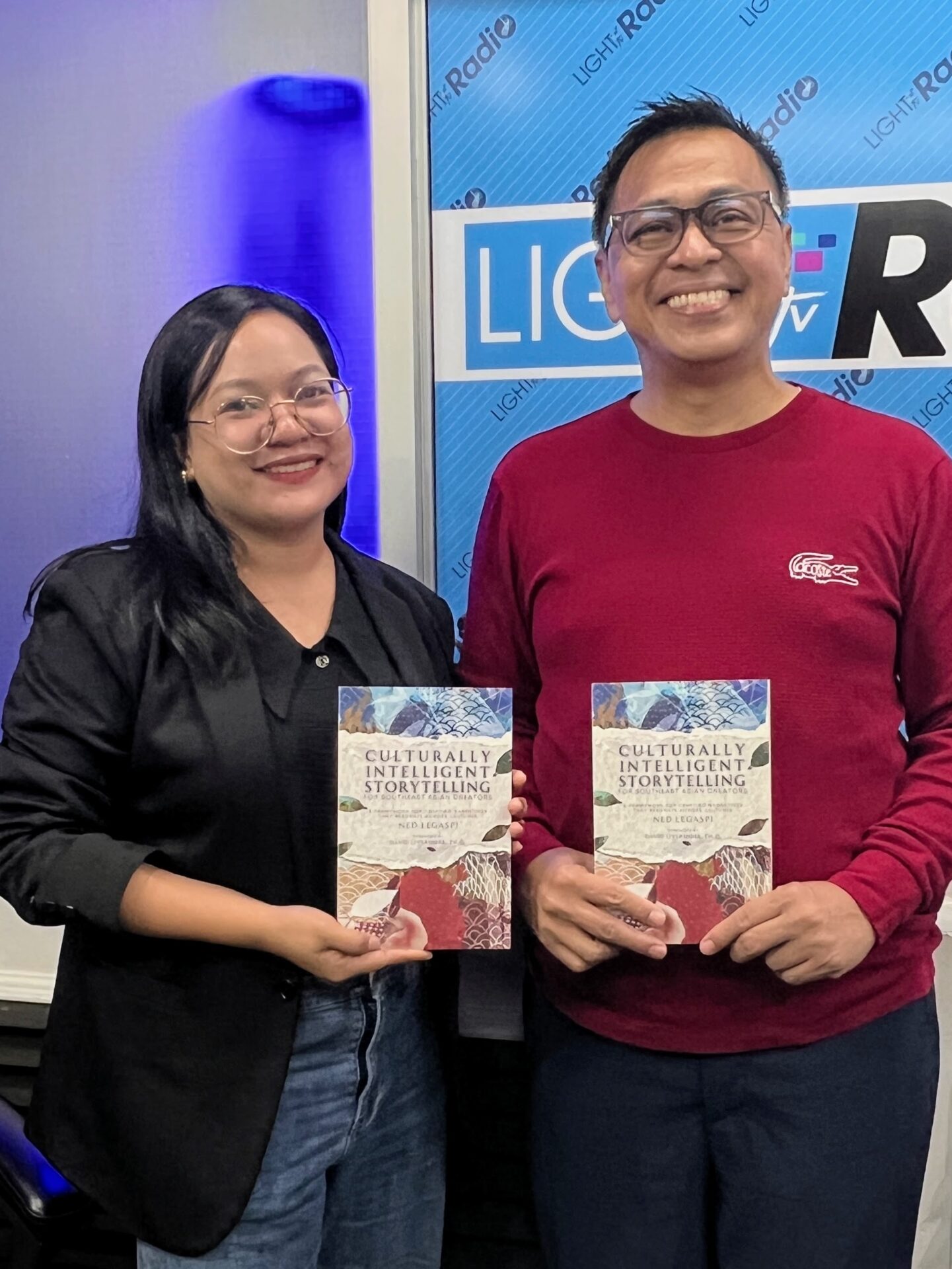 Annie Lyn Cristobal with a copy of Culturally Intelligent Storytelling for Southeast Asian Creators