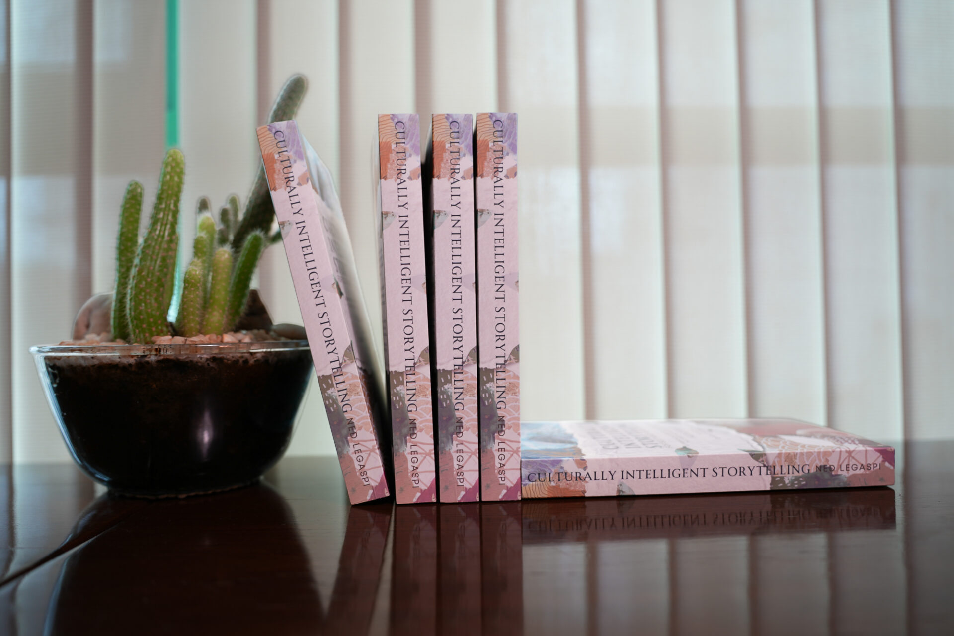 Copies of Culturally Intelligent Storytelling for Southeast Asian Creators displayed beside a cactus ahead of the Ateneo Philippine launch.