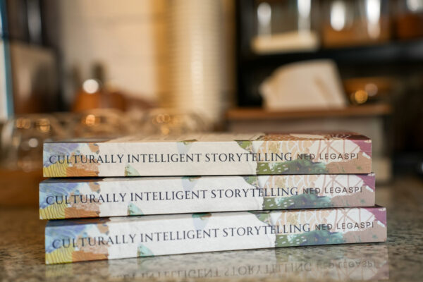 Three copies of Culturally Intelligent Storytelling for Southeast Asian Creators displayed on a reflective table.