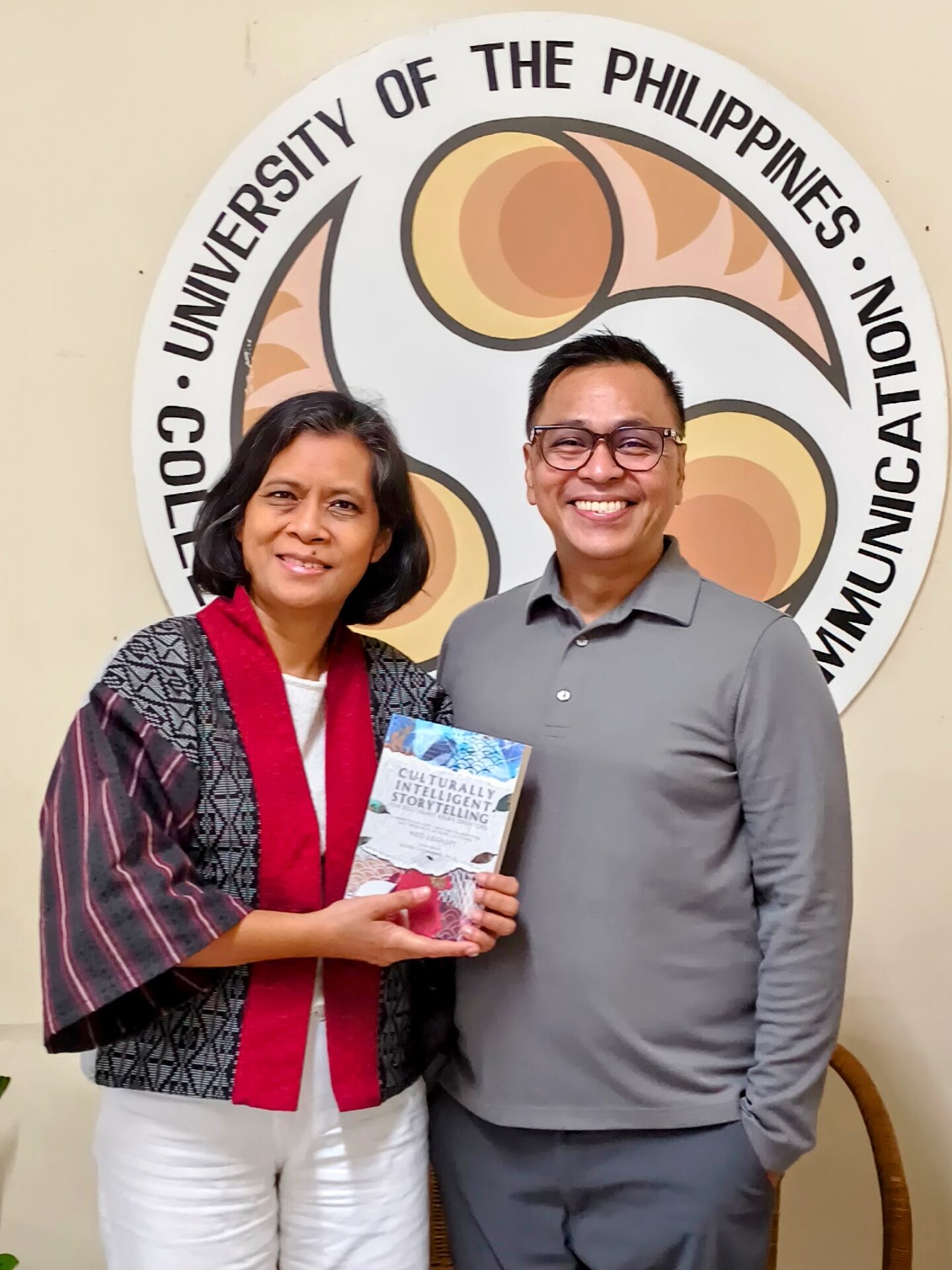 Dean Diosa Labiste and Ned Legaspi with a copy of Culturally Intelligent Storytelling for Southeast Asian Creators