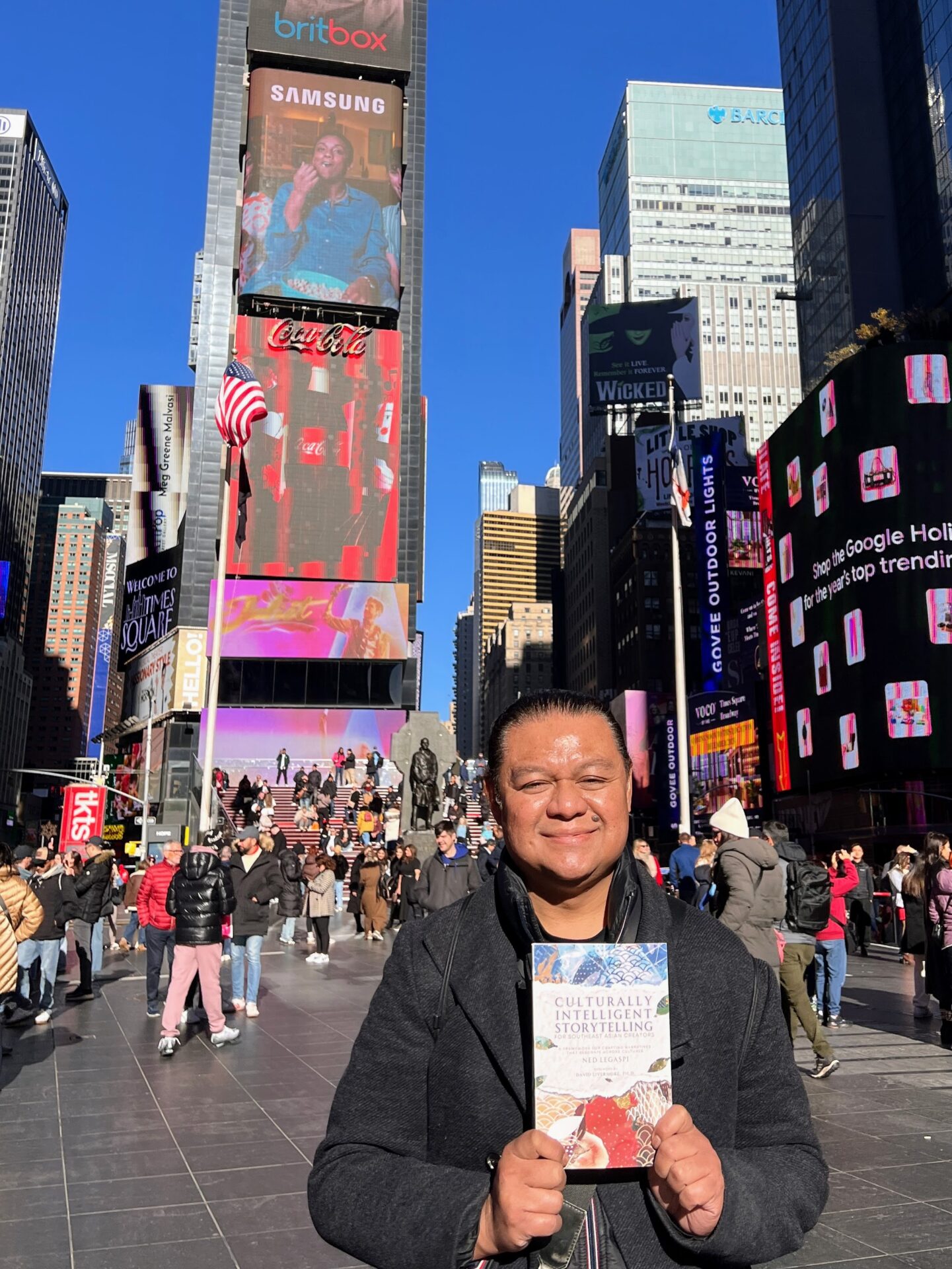 Don Tagala with a copy of Culturally Intelligent Storytelling for Southeast Asian Creators