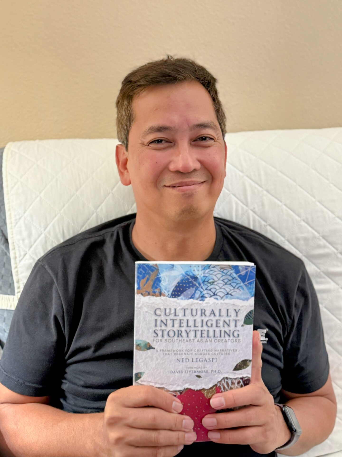 Edwin Legaspi with a copy of Culturally Intelligent Storytelling for Southeast Asian Creators