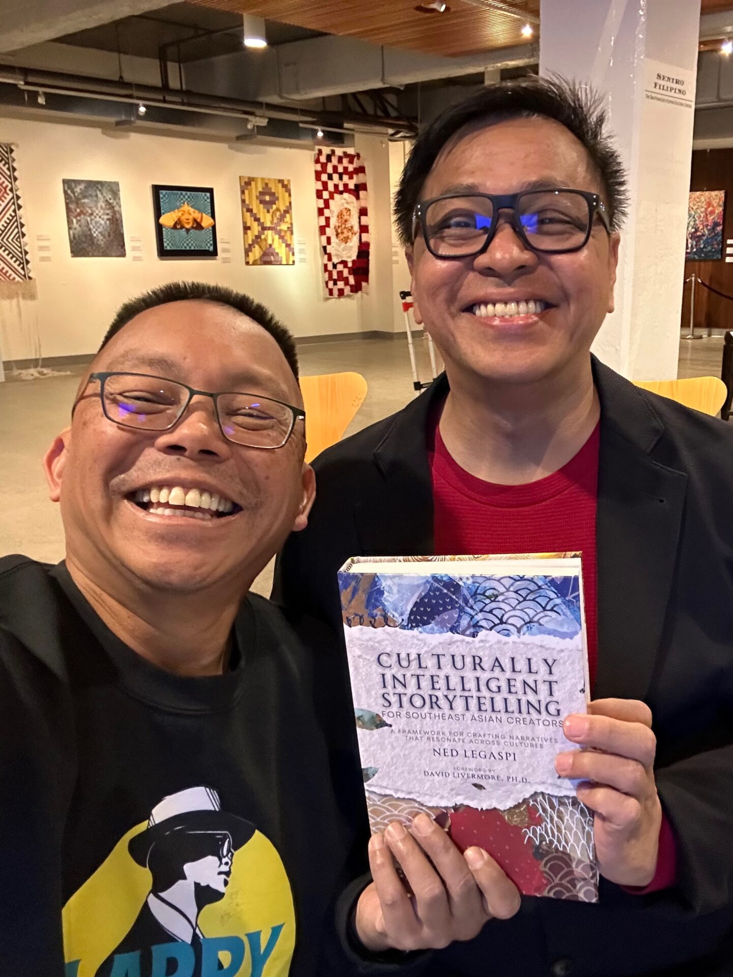 Eugene Libadia with a copy of Culturally Intelligent Storytelling for Southeast Asian Creators