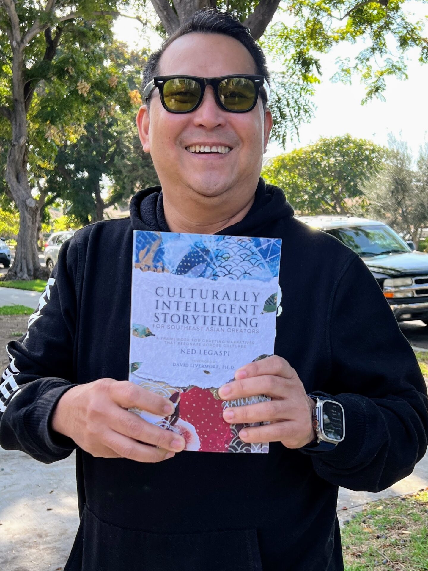 Flavio Bautista with a copy of Culturally Intelligent Storytelling for Southeast Asian Creators