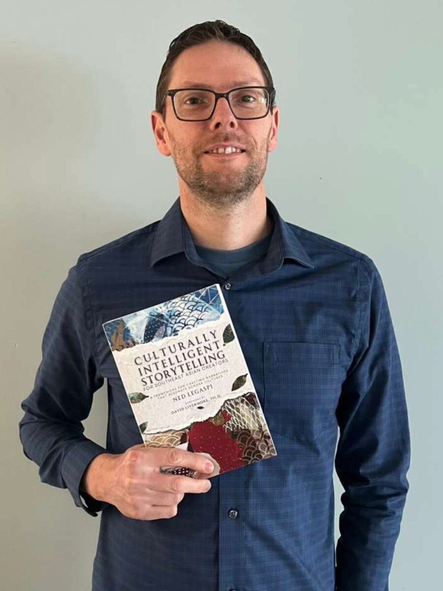 Graham McKeague holding a copy of Culturally Intelligent Storytelling for Southeast Asian Creators