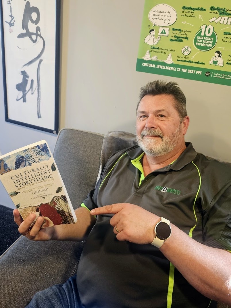 Greg Dearsly holding a copy of Culturally Intelligent Storytelling for Southeast Asian Creators