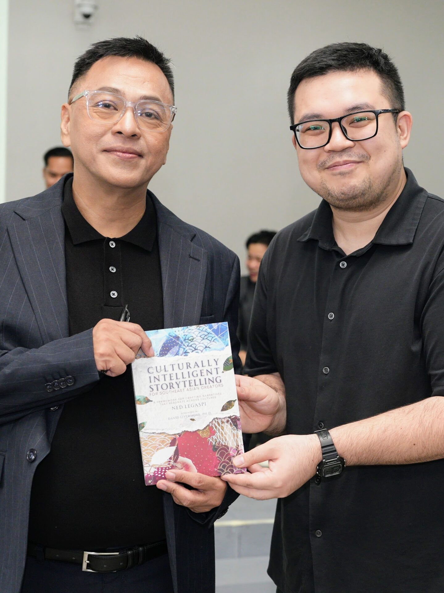 John Peter Chua with a copy of Culturally Intelligent Storytelling for Southeast Asian Creators