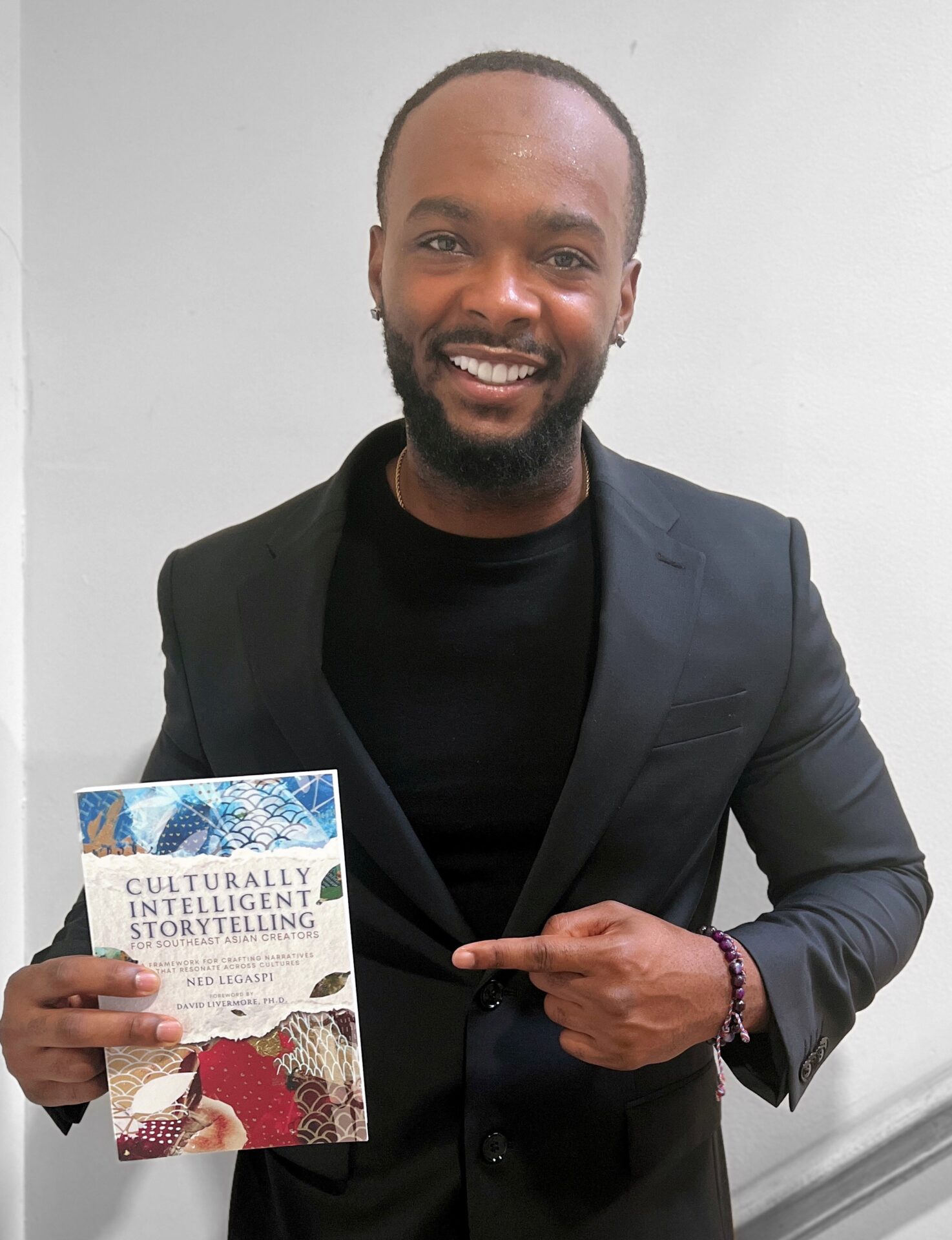 Jon Campbell with a copy of Culturally Intelligent Storytelling for Southeast Asian Creators
