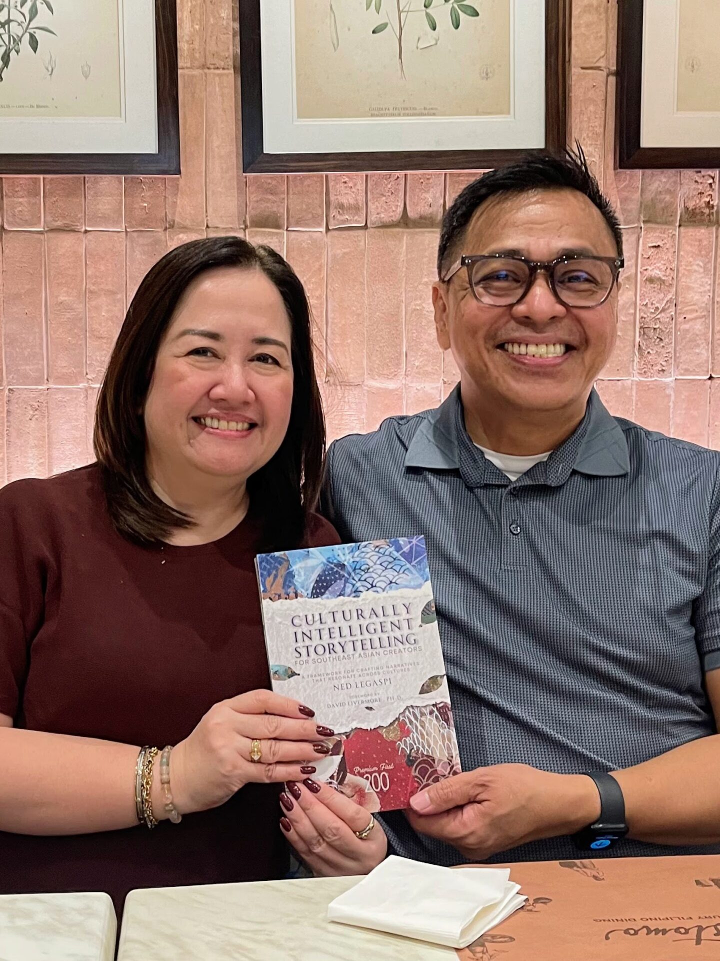 Lanie Zacarias-Fadriquela with a copy of Culturally Intelligent Storytelling for Southeast Asian Creators