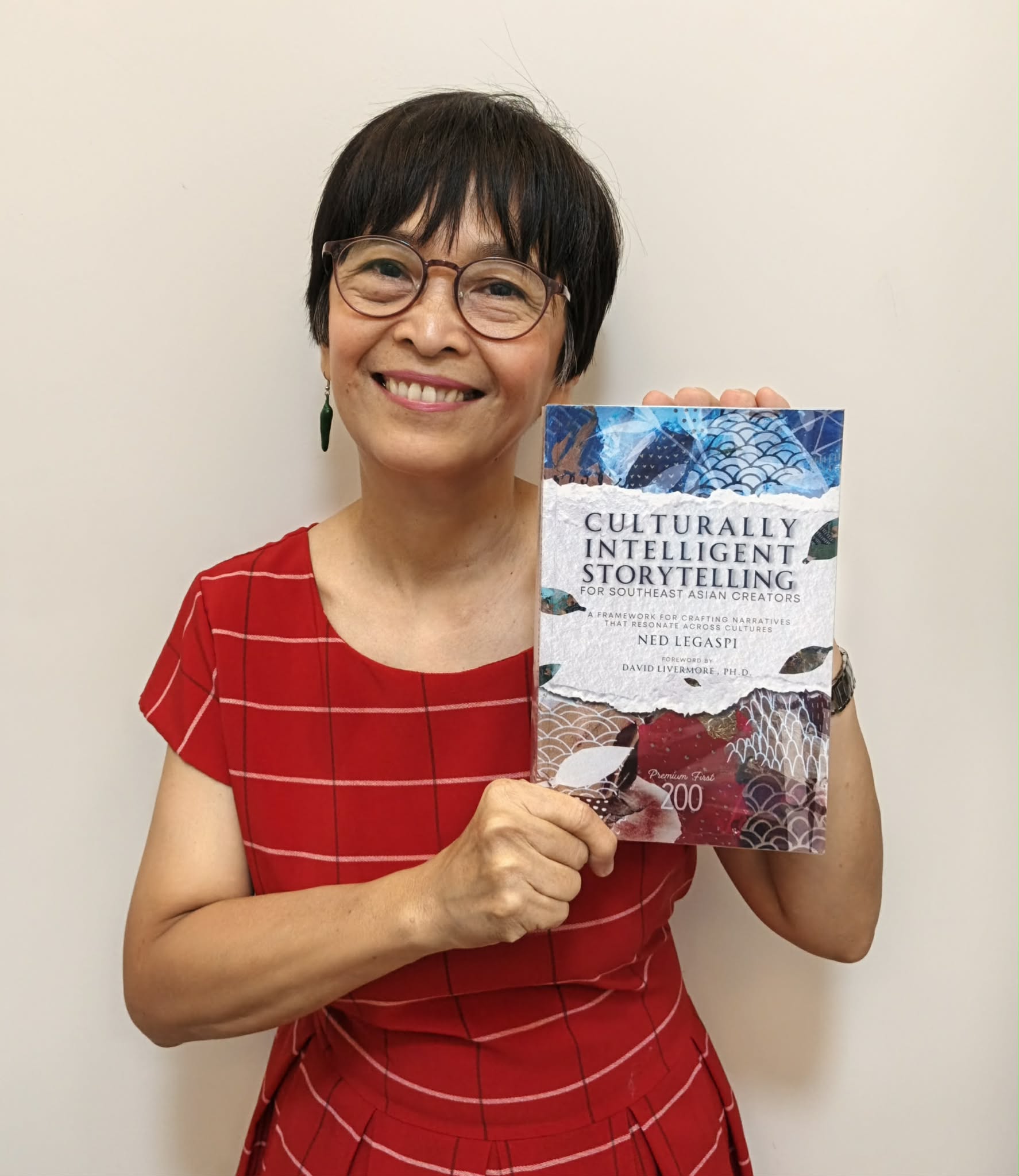 Marlene Legaspi-Munar holding a copy of Culturally Intelligent Storytelling for Southeast Asian Creators