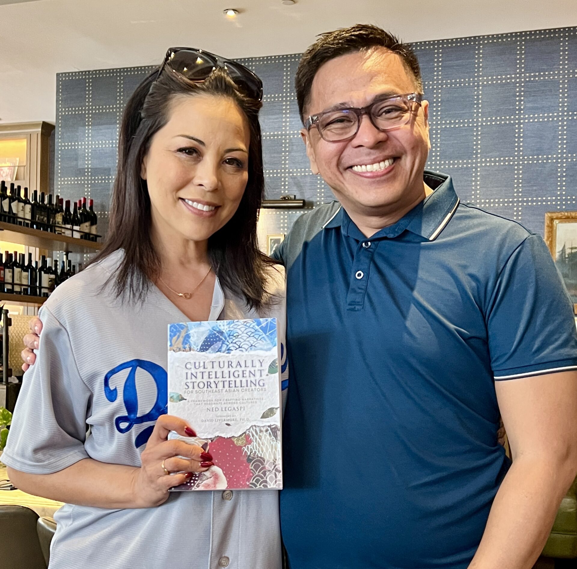 Cher Calvin with a copy of Culturally Intelligent Storytelling for Southeast Asian Creators