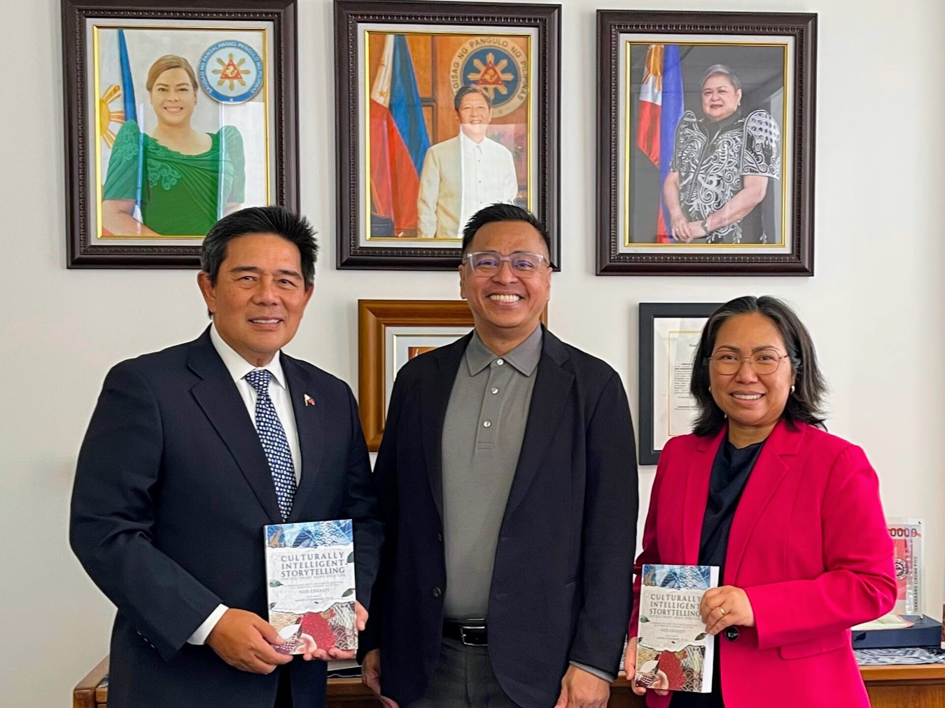 Ned Legaspi with Consul General Adelio Angelito S. Cruz and Deputy Consul General Maria Alnee A. Gamble holding copies of Culturally Intelligent Storytelling for Southeast Asian Creators