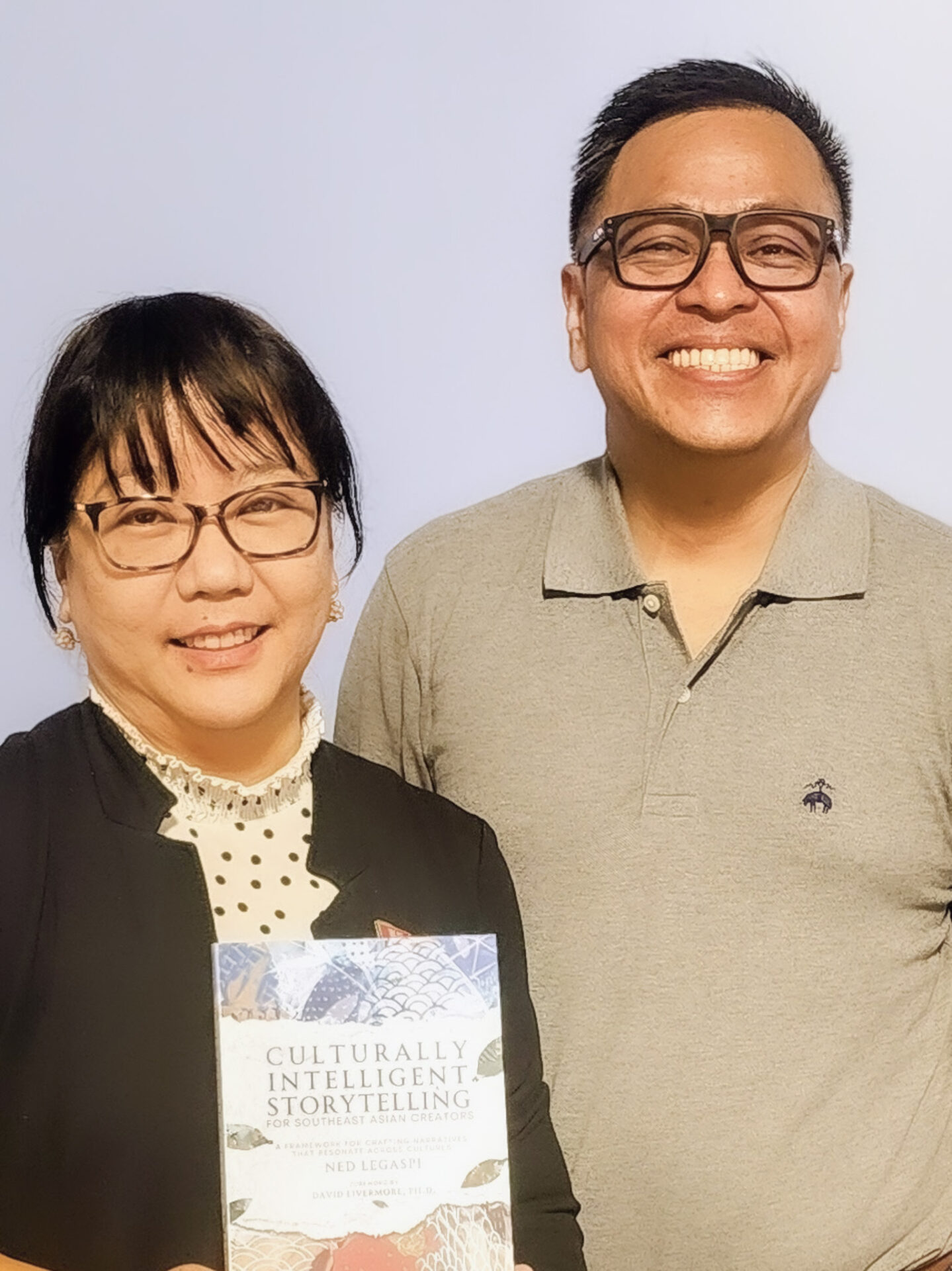 Janeth Zafra-Mauricio with a copy of Culturally Intelligent Storytelling for Southeast Asian Creators