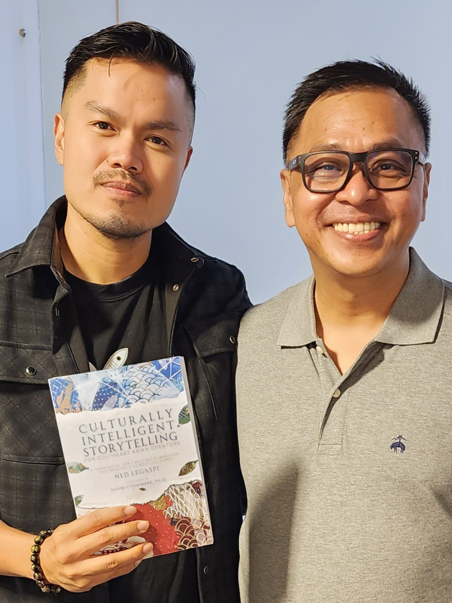 Mark Labella with a copy of Culturally Intelligent Storytelling for Southeast Asian Creators