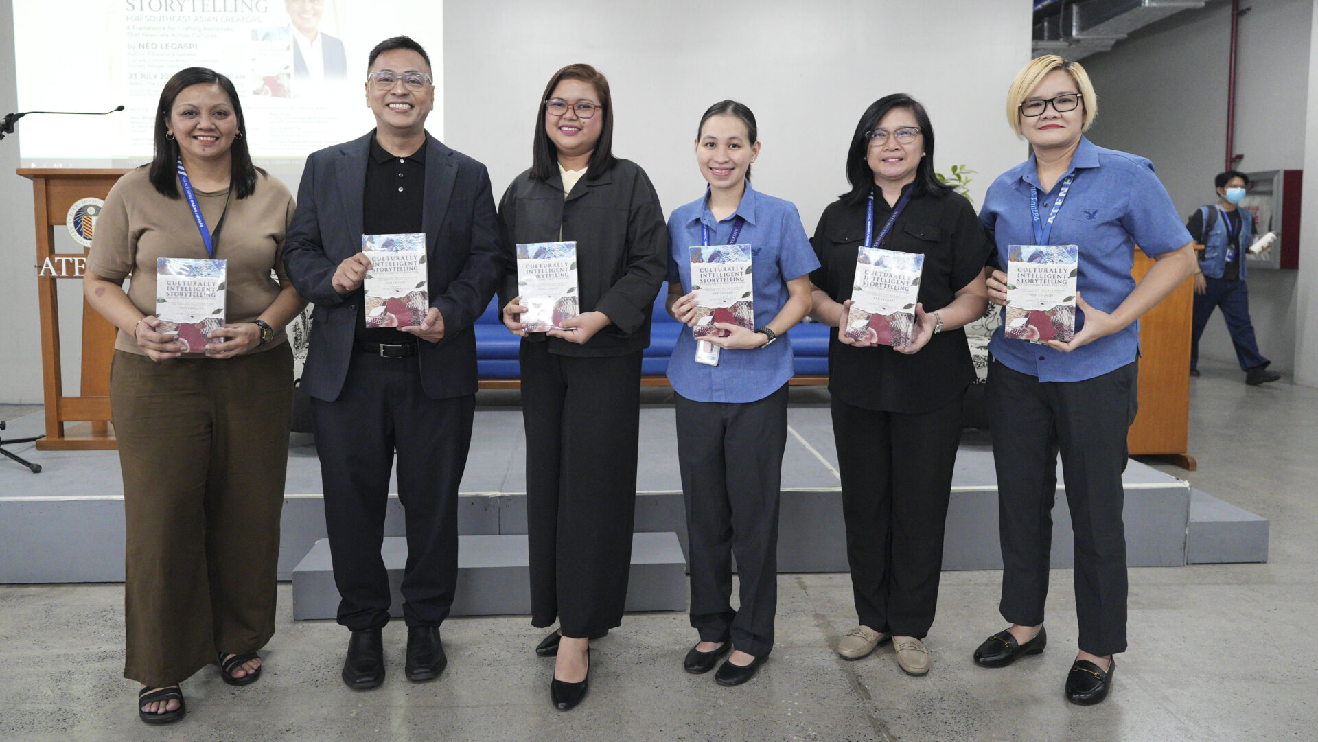 Ned Legaspi with University Librarian Joenabie E. Arevalo and Rizal Library leaders during the ceremonial book donation