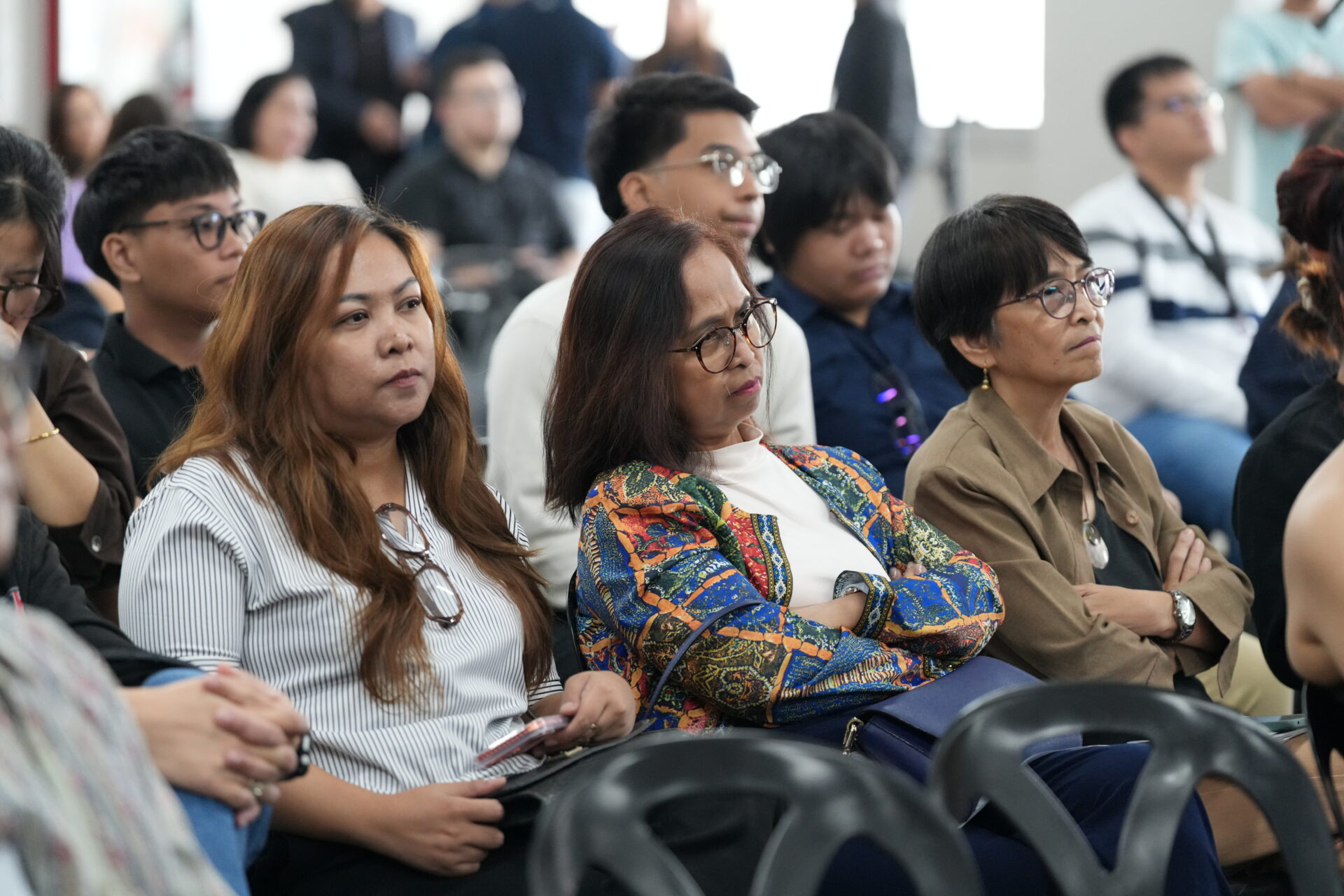 Ned Legaspi speaking as his siblings Rachelle, Shirley, and Marlene watch from the audience