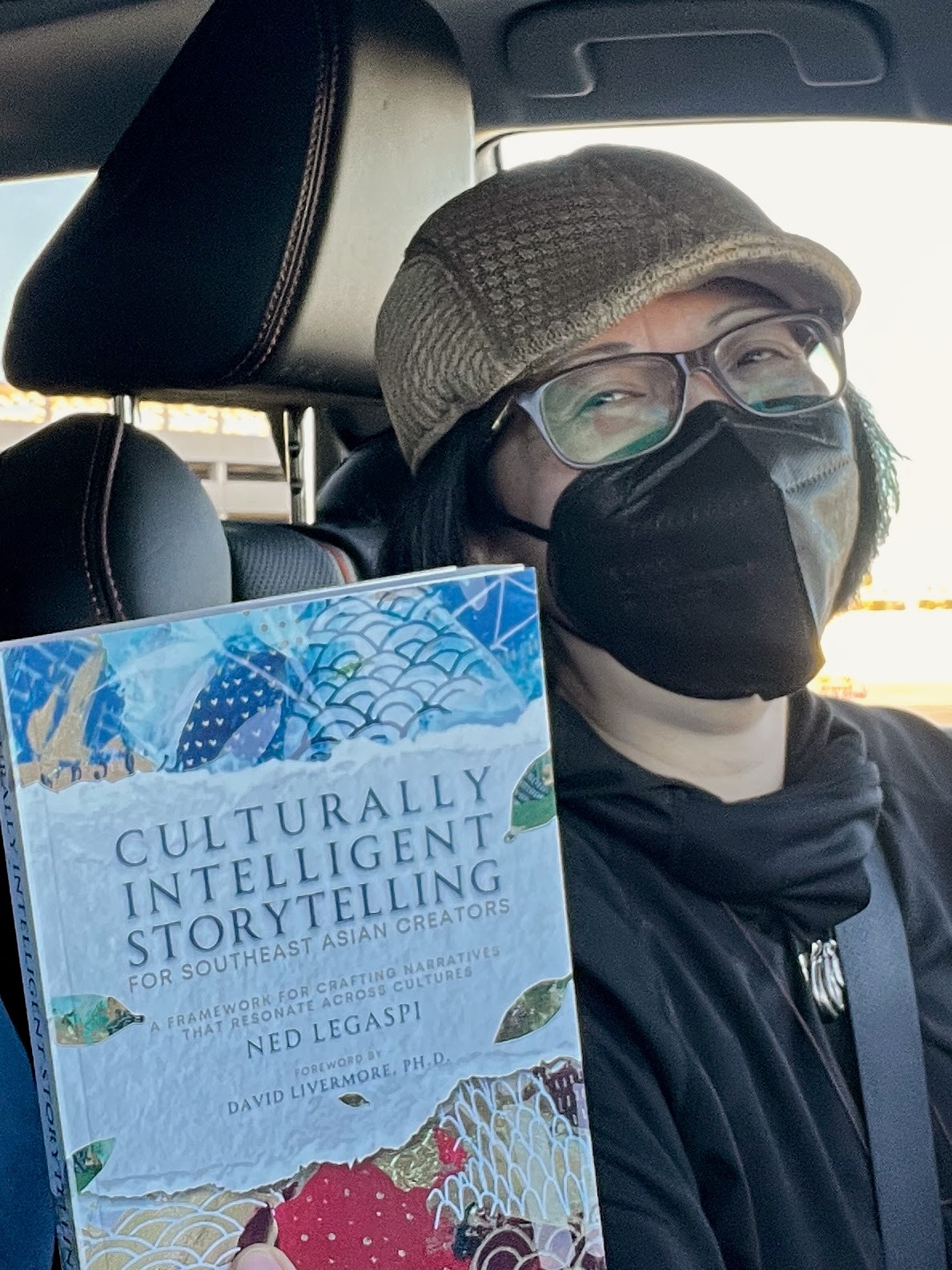 Nerissa Fernandez with a copy of Culturally Intelligent Storytelling for Southeast Asian Creators