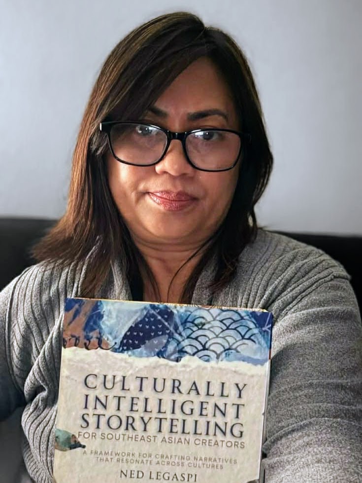 Ofelia Szell with a copy of Culturally Intelligent Storytelling for Southeast Asian Creators
