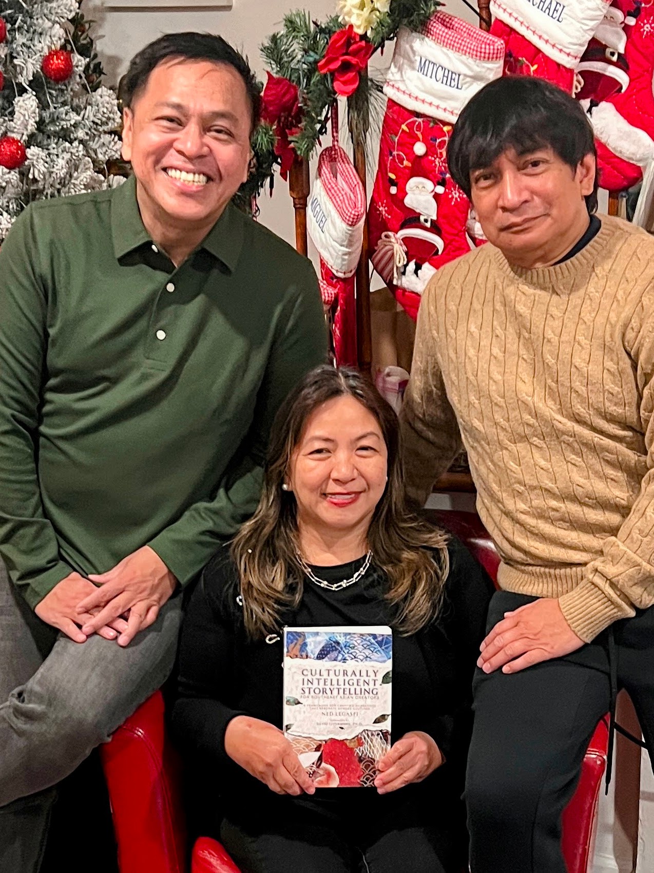 Onette Namit and Kuya Noriel with a copy of Culturally Intelligent Storytelling for Southeast Asian Creators