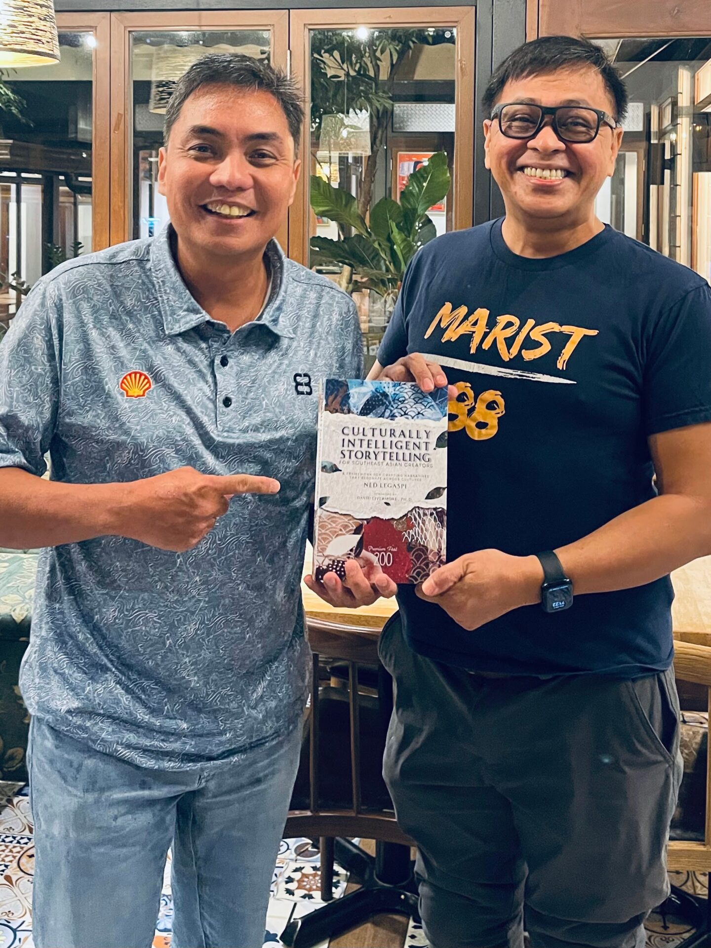 Paulo Gavino with a copy of Culturally Intelligent Storytelling for Southeast Asian Creators