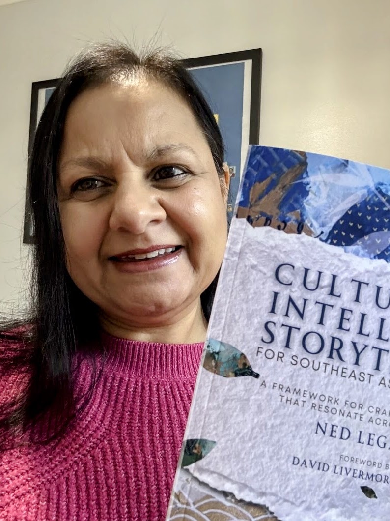 Shahana Ramsden with a copy of Culturally Intelligent Storytelling for Southeast Asian Creators in England, United Kingdom