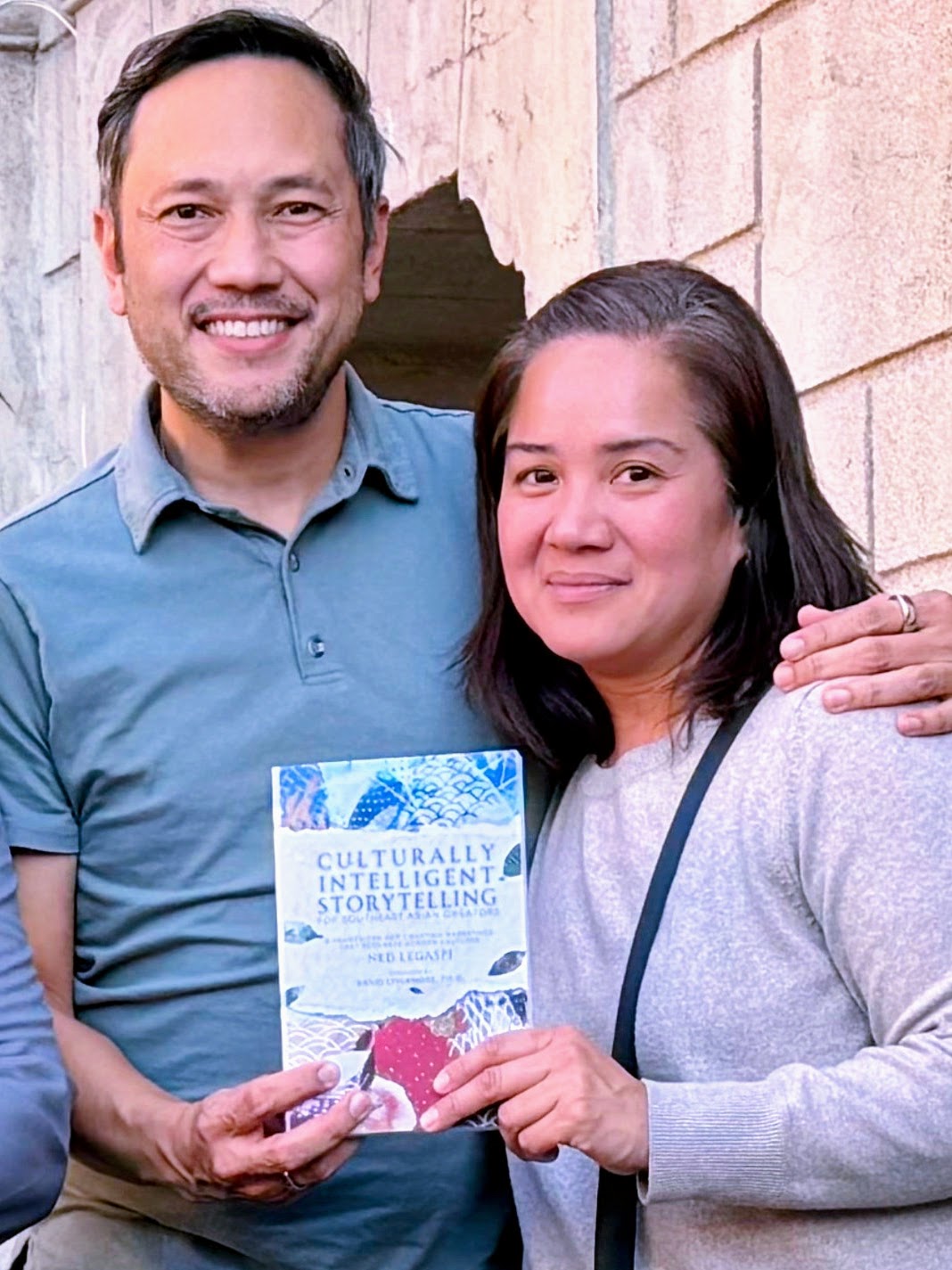 TJ and Rio Manotoc with a copy of Culturally Intelligent Storytelling for Southeast Asian Creators