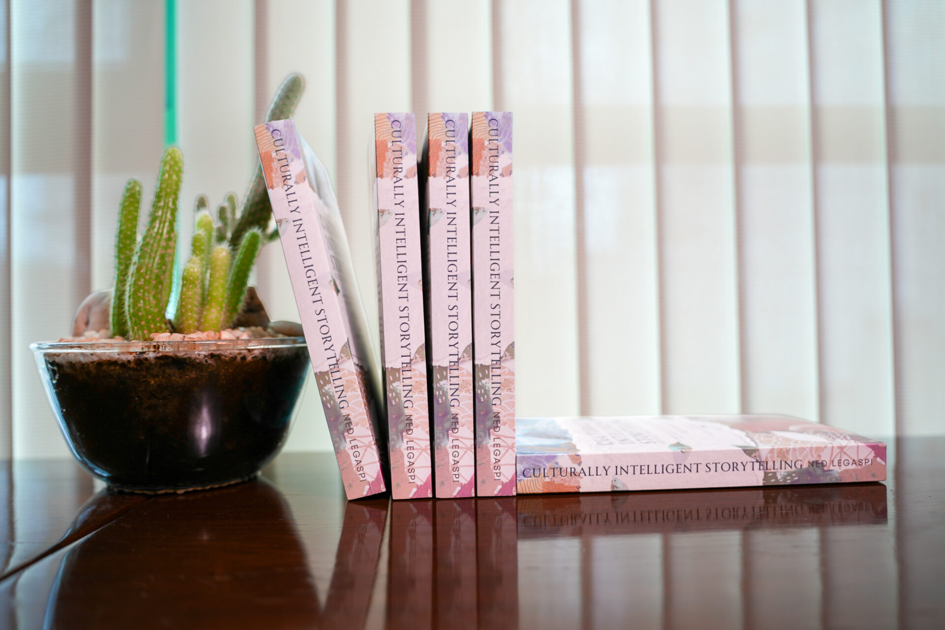 Copies of Culturally Intelligent Storytelling for Southeast Asian Creators displayed beside a cactus